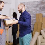 man-from-delivery-service-arriving-with-boxes-documents-be-signed-beautiful-young-couple-moving_482257-22217